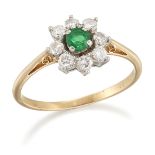 AN EMERALD AND DIAMOND CLUSTER RING