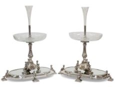 A HANDSOME PAIR OF 19TH CENTURY SILVER-PLATED CENTREPIECES ON MIRRORED STANDS