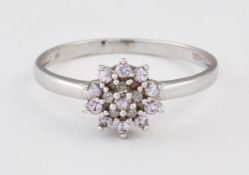 A 9 CARAT WHITE GOLD PINK STONE AND DIAMOND CLUSTER RING