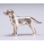 AN ELIZABETH II CAST SILVER MODEL OF A DOG