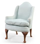 AN EARLY 20TH CENTURY WALNUT AND UPHOLSTERED WING-BACK ARMCHAIR