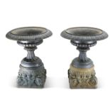 A LARGE AND IMPRESSIVE PAIR OF CAST IRON URNS