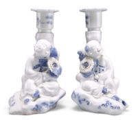A PAIR OF JAPANESE HIRADO BLUE AND WHITE FIGURAL CANDLESTICKS