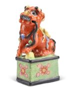 A CHINESE CLOBBERED MODEL OF A FOO DOG