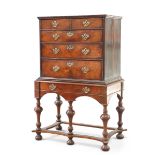 AN 18TH CENTURY WALNUT CHEST ON LATER STAND