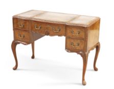 A GEORGIAN STYLE LEATHER-INSET WALNUT WRITING DESK