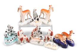 A COLLECTION OF STAFFORDSHIRE POTTERY DOG MODELS