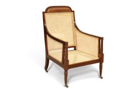 AN EDWARDIAN MAHOGANY AND CANEWORK BERGÈRE