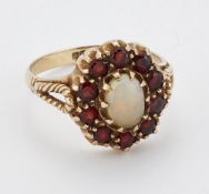 A 9 CARAT GOLD OPAL AND GARNET CLUSTER RING