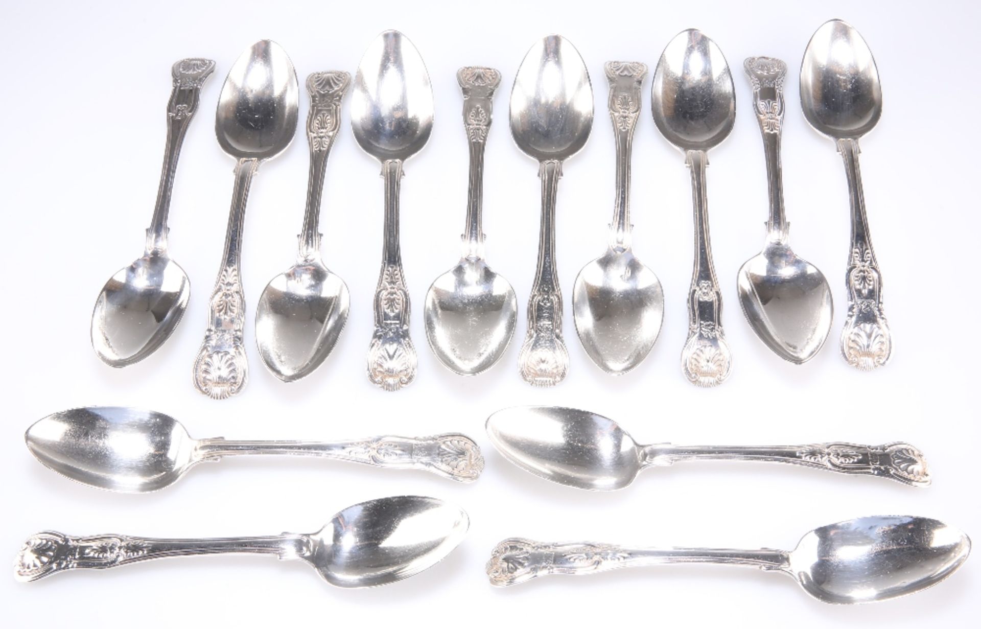 A MATCHED SET OF ELEVEN GEORGIAN AND VICTORIAN SILVER DESSERT SPOONS