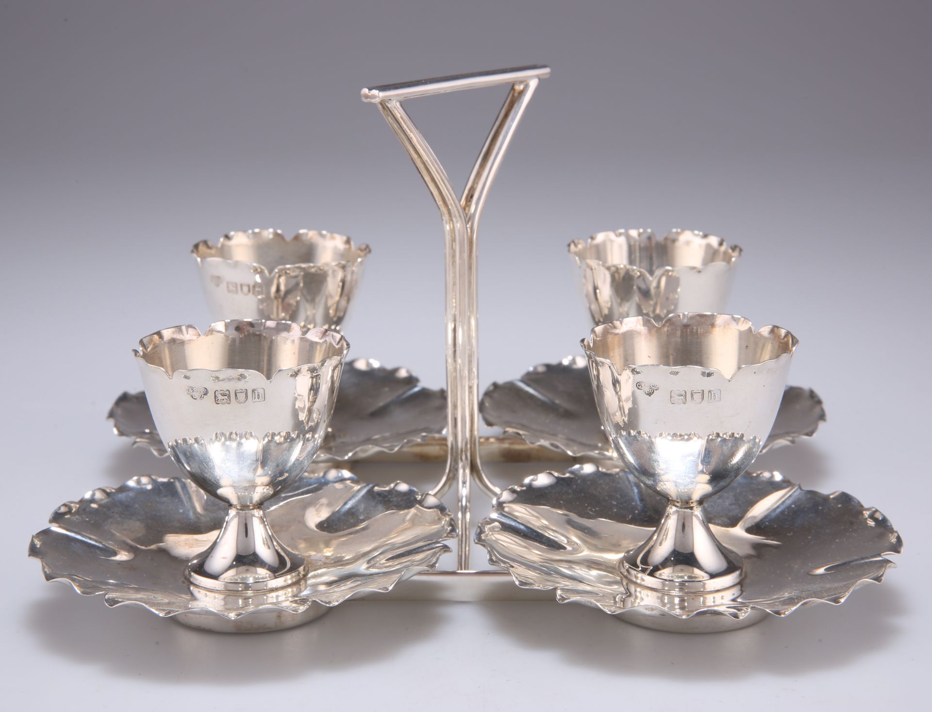 AN EDWARDIAN SILVER EGG CRUET SUITE