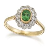 AN 18 CARAT GOLD GREEN GARNET AND DIAMOND CLUSTER RING