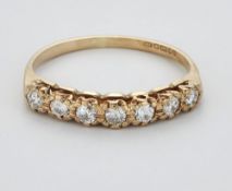 A 9 CARAT GOLD DIAMOND HALF HOOP RING