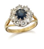 AN 18 CARAT GOLD SAPPHIRE AND DIAMOND CLUSTER RING