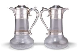 A PAIR OF VICTORIAN SILVER-MOUNTED CLARET JUGS