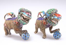 A PAIR OF CHINESE SILVER AND ENAMEL MODELS OF BUDDHIST LIONS