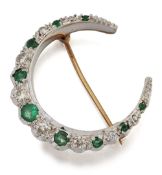 A 9 CARAT BI-COLOUR GOLD EMERALD AND DIAMOND CRESCENT BROOCH