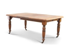 A VICTORIAN OAK WIND-OUT EXTENDING DINING TABLE