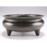 A CHINESE BRONZE TRIPOD CENSER