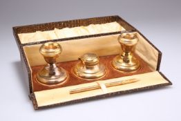 A PAIR OF GEORGE V SILVER-GILT CANDLESTICKS AND INKWELL