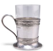 AN ARTS AND CRAFTS SILVER TEA GLASS HOLDER
