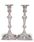 A PAIR OF GEORGE III CAST SILVER CANDLESTICKS