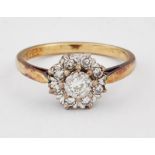 AN 18 CARAT GOLD DIAMOND CLUSTER RING