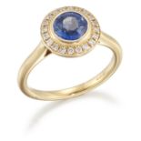 AN 18 CARAT GOLD SAPPHIRE AND DIAMOND CLUSTER RING