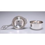 A GEORGE V SILVER TEA STRAINER ON STAND