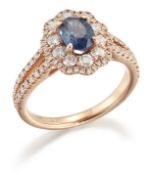 AN 18 CARAT GOLD SAPPHIRE AND DIAMOND CLUSTER RING