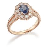 AN 18 CARAT GOLD SAPPHIRE AND DIAMOND CLUSTER RING