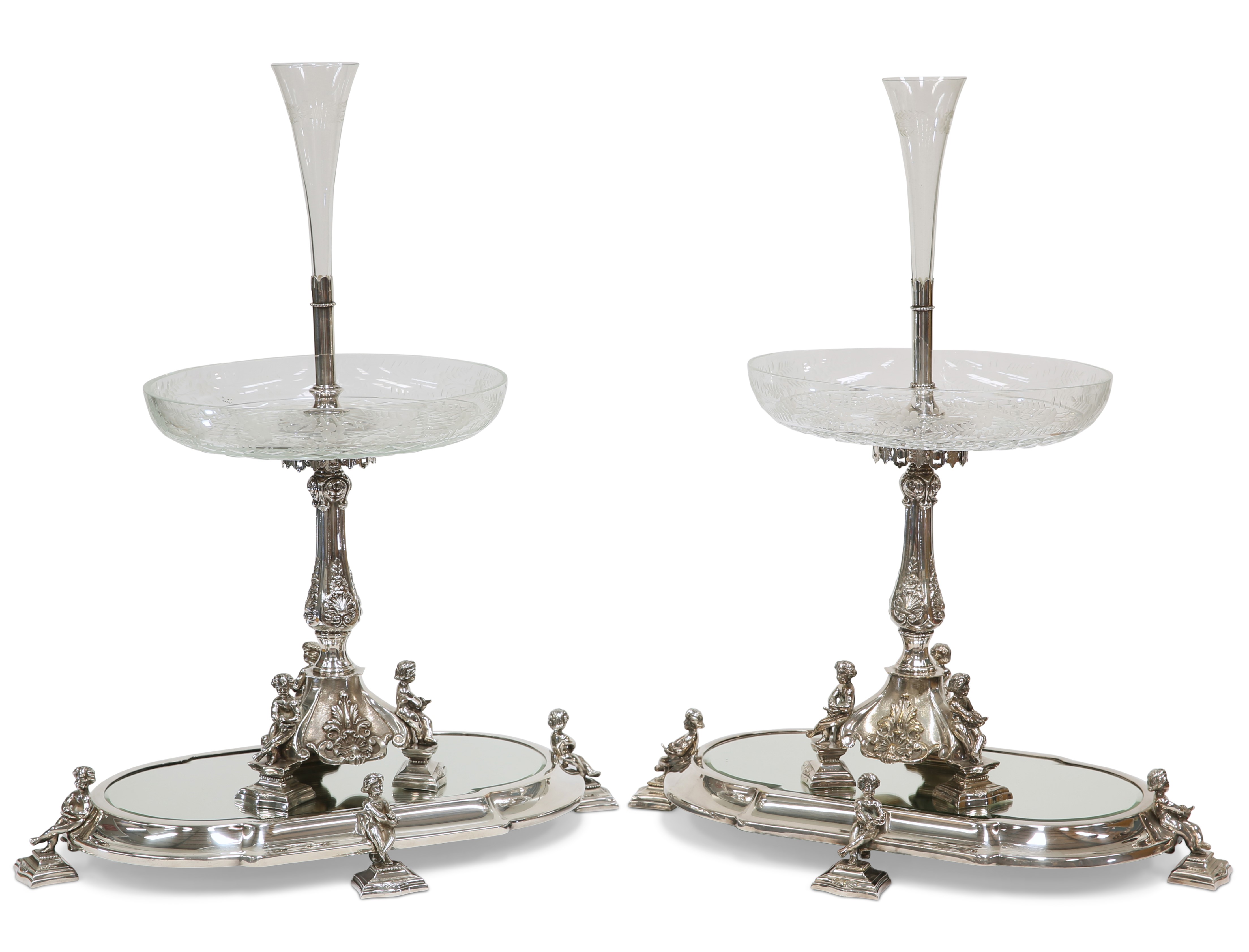 A HANDSOME PAIR OF 19TH CENTURY SILVER-PLATED CENTREPIECES ON MIRRORED STANDS