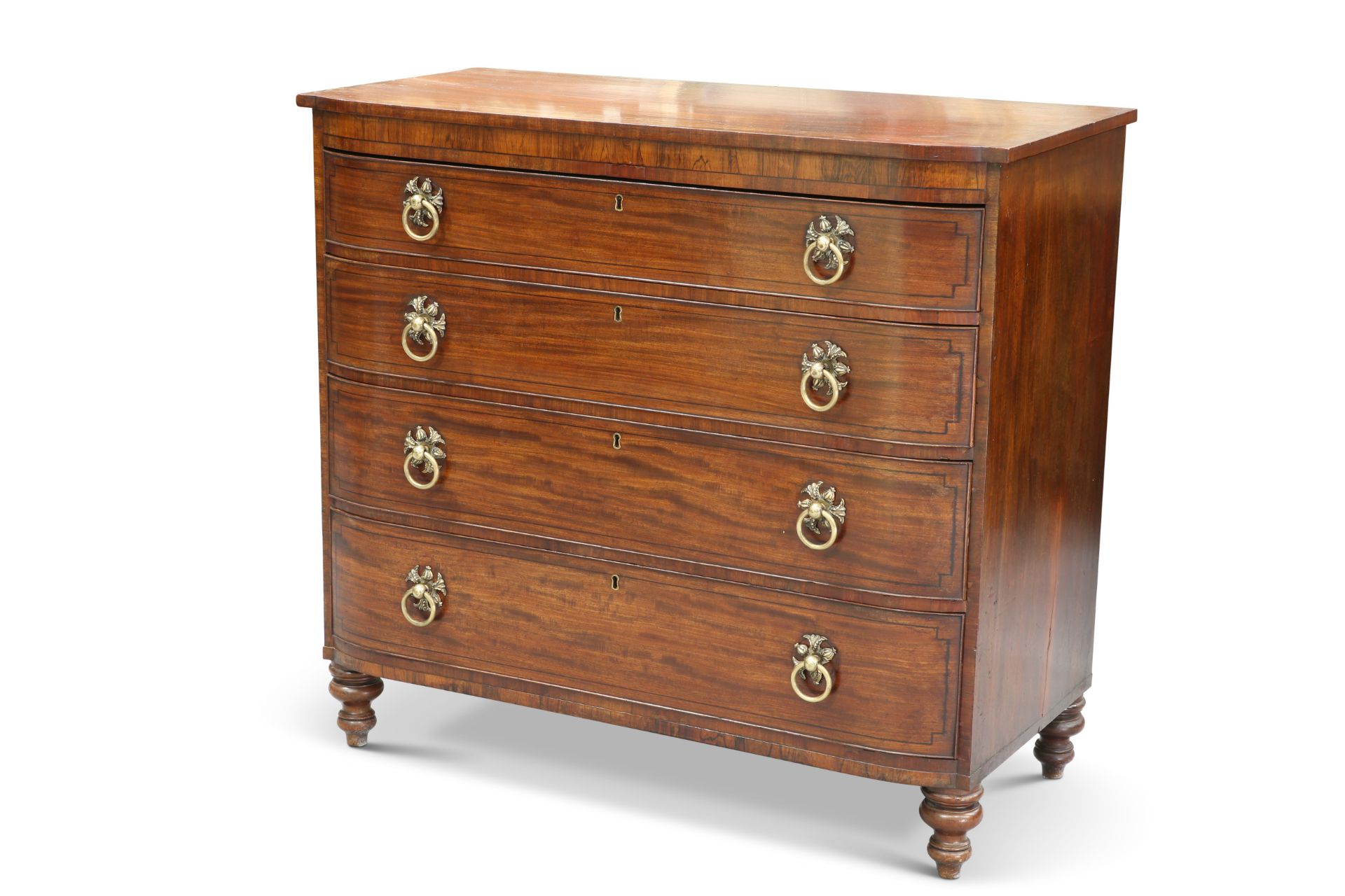 A REGENCY MAHOGANY AND ROSEWOOD CHEST OF DRAWERS
