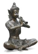 A THAI LARGE BRONZE OF A FLAUTIST