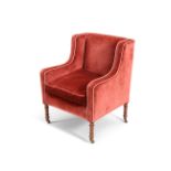 A LATE REGENCY MAHOGANY AND UPHOLSTERED LIBRARY ARMCHAIR