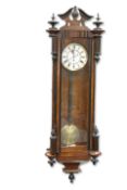 A GERMAN EBONISED AND WALNUT VIENNA-PATTERN WALL CLOCK