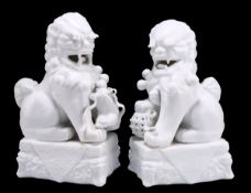 A NEAR PAIR OF CHINESE BLANC DE CHINE MODELS OF BUDDHIST LIONS