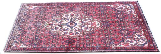 A PERSIAN HOSSEINABAD RUG