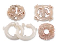 FOUR CHINESE CARVED JADE PENDANTS