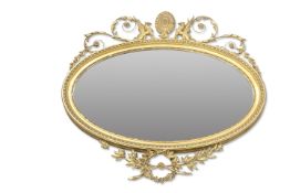 A 19TH CENTURY GILT-COMPOSTITION OVAL MIRROR