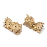 A PAIR OF 19TH CENTURY CHINESE GILTWOOD CARVINGS OF FU DOGS