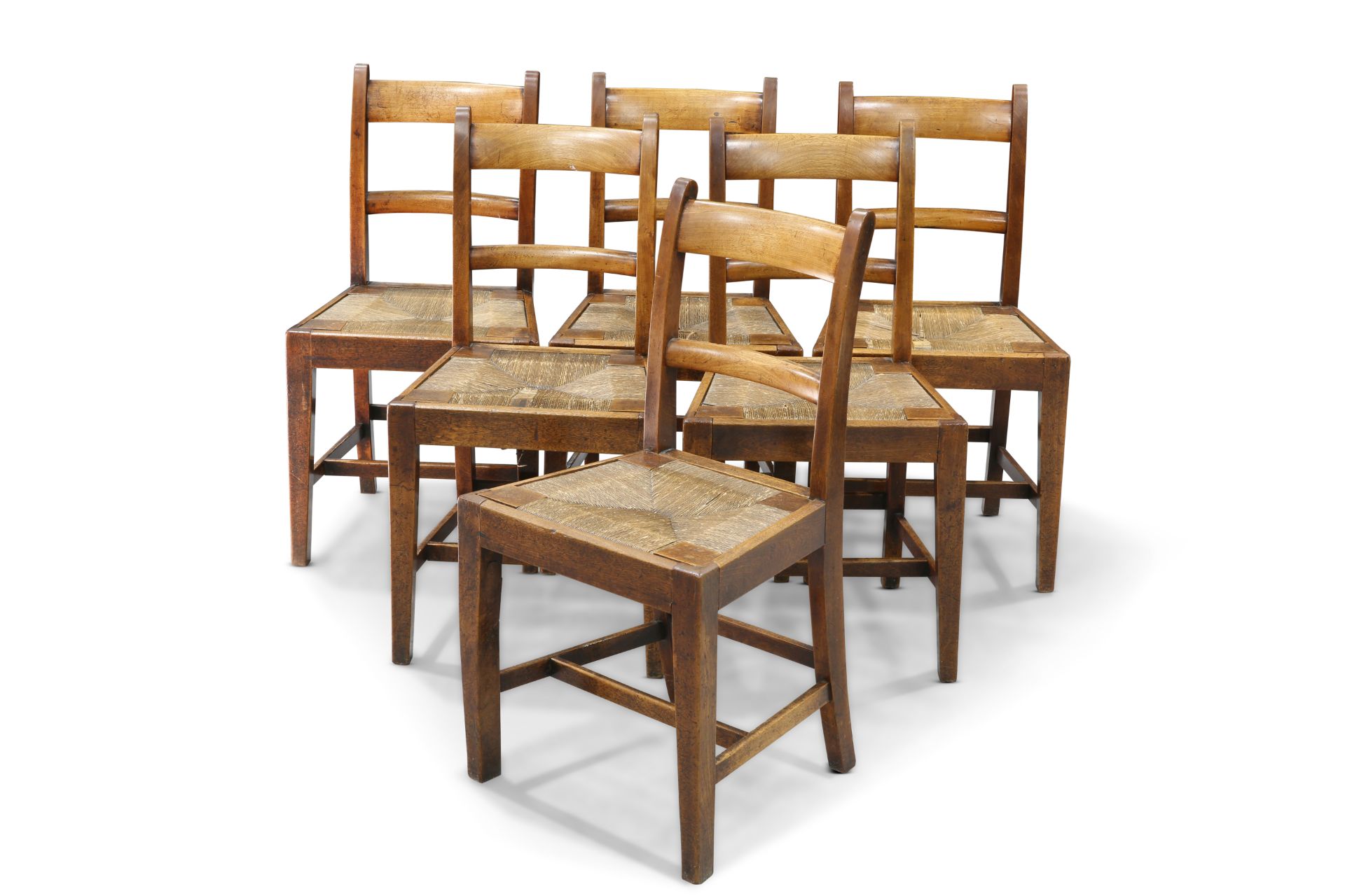 A SET OF SIX 19TH CENTURY COUNTRY BEECH AND RUSH SEATED DINING CHAIRS