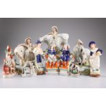 A group of Staffordshire figures comprising two milkmaids and a cow herd, largest 25cm high, a