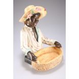 Continental faience figure in straw hat holding a basket, 40cm high (Chip to hat)