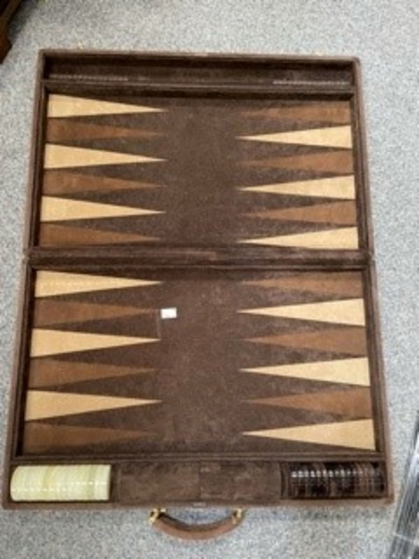A suede leather bound backgammon set by Zarach complete with counters, 62cm by 40cm