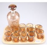A silver and ochre coloured glass drinking set comprising decanter and 12 tumblers 6cm high