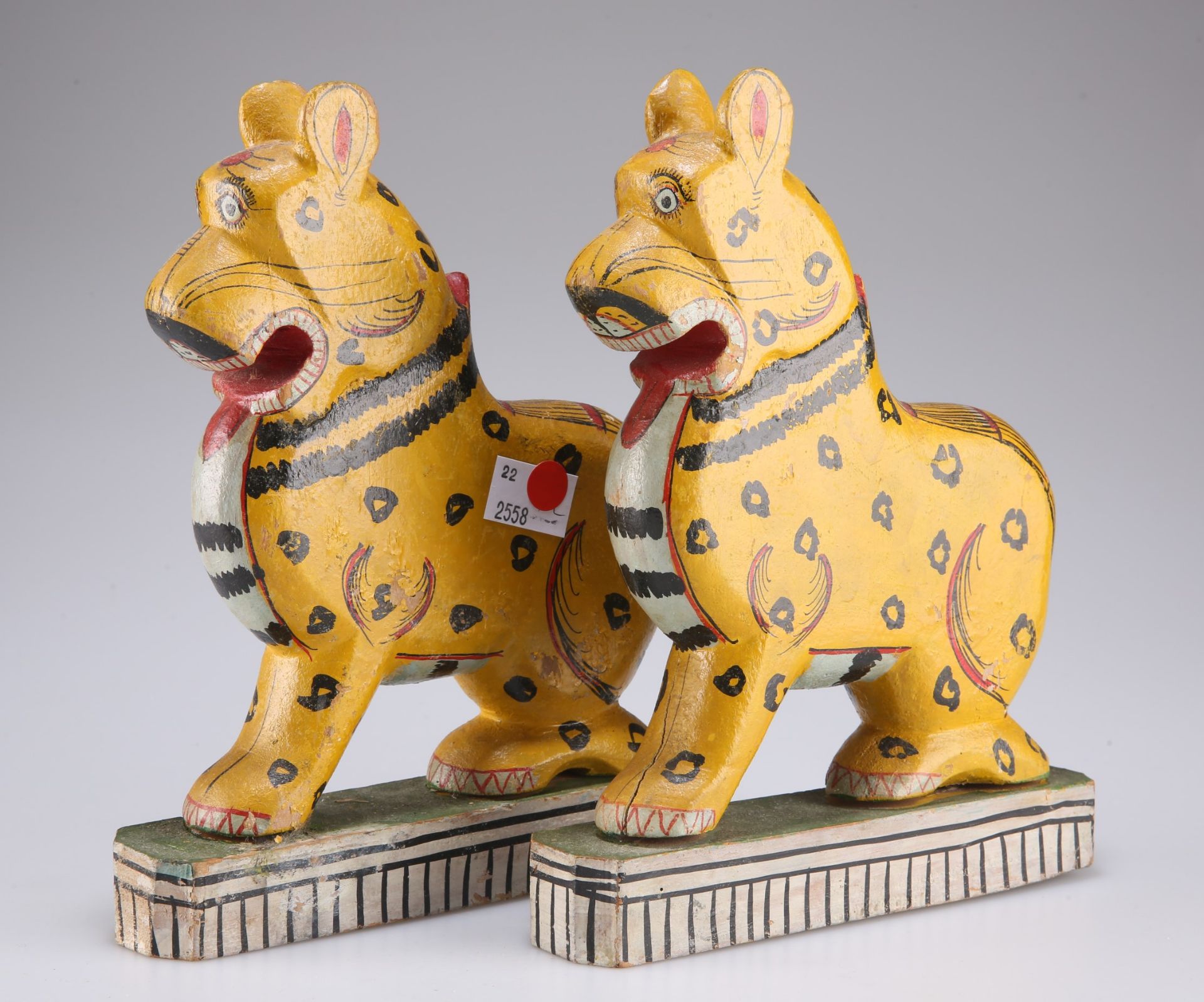 A pair of Odisha East Indian hand carved and painted figures of leopard on green painted rectangular