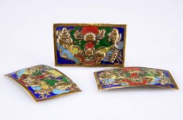 A set of three enamelled brass plaques, probably Chinese