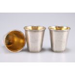 Three small Continental silver tots with gilt interiors, stamped marks to base, 4cm high