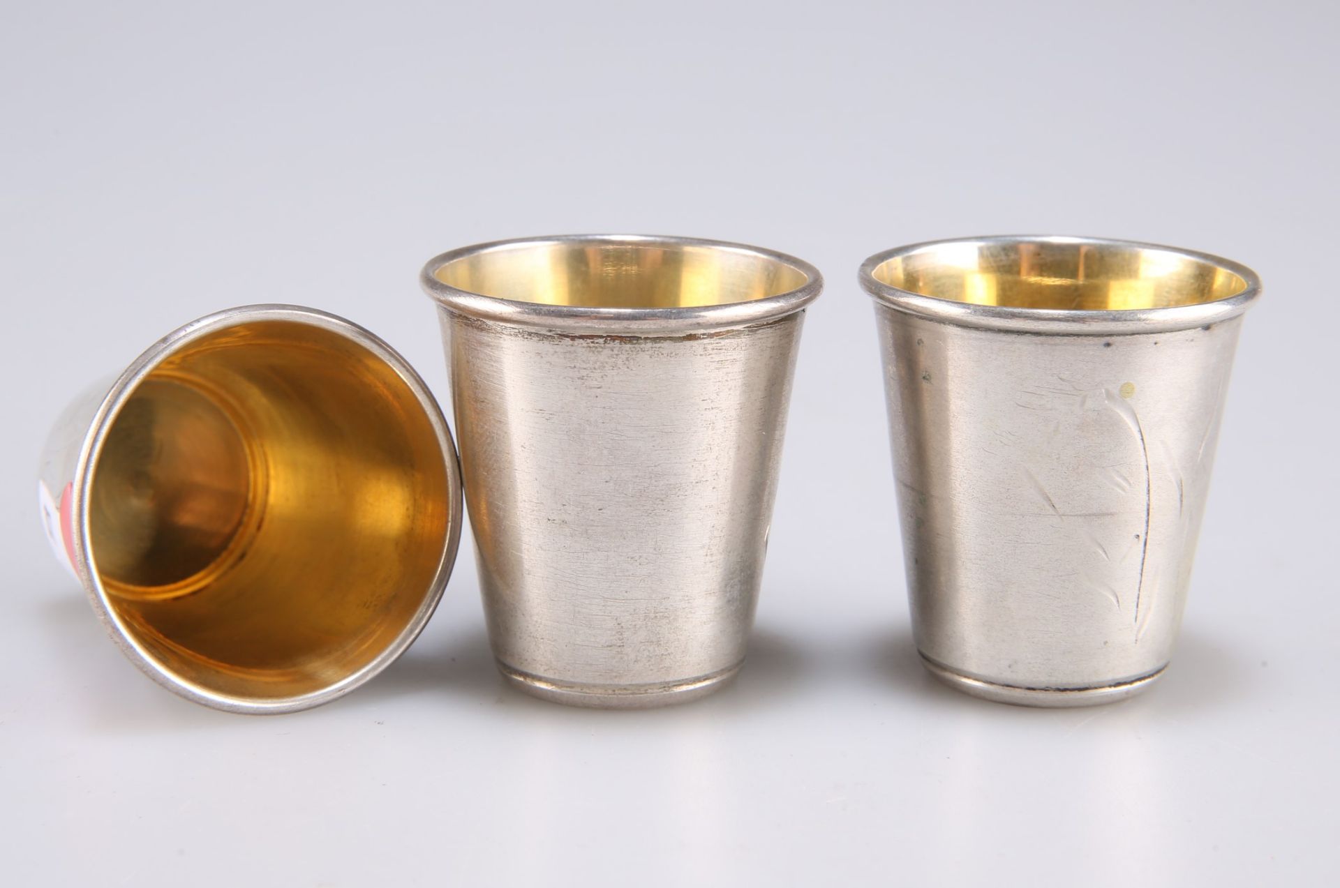 Three small Continental silver tots with gilt interiors, stamped marks to base, 4cm high